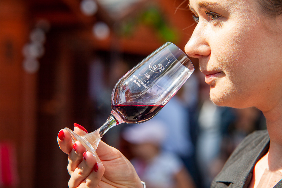 Kobieta degustująca czerwone wino z kieliszka